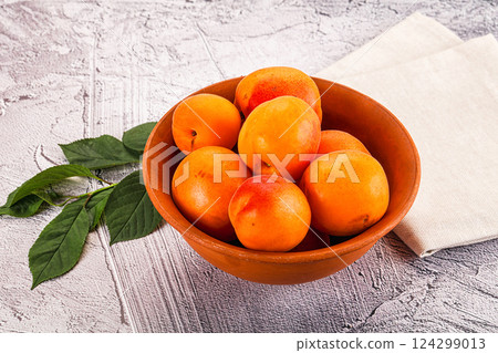 Raw ripe sweet apricots heap 124299013