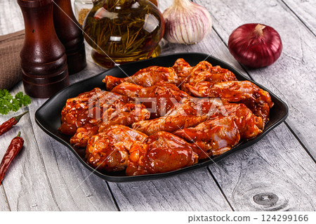 Raw marinated buffalo chicken wings Raw marinated buffalo chicken wings 124299166