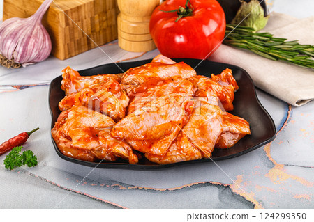 Raw marinated uncooked chicken wings 124299350