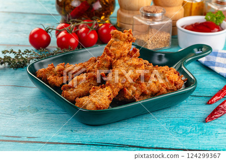 Golden crispy fried chicken strips 124299367