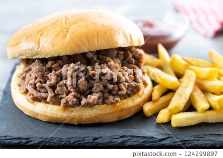 Traditional sloppy joe sandwich with french fries on wooden table 124299897