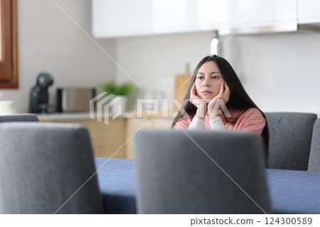 Apathetic asian woman in the kitchen Apathetic asian woman in the kitchen 124300589