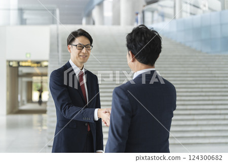 Two businessmen shaking hands Two businessmen shaking hands 124300682
