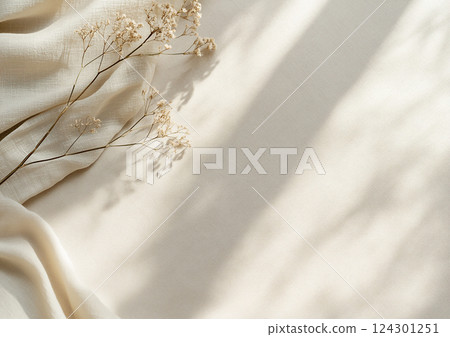 Dried flowers on beige organic fabric with delicate shadows. Minimalist boho white background. 124301251