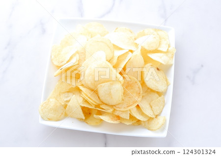 A pile of potato chips on a plate 124301324