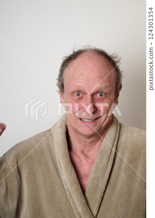 Old man beige bathrobe and tousled hair Old man beige bathrobe and tousled hair 124301354
