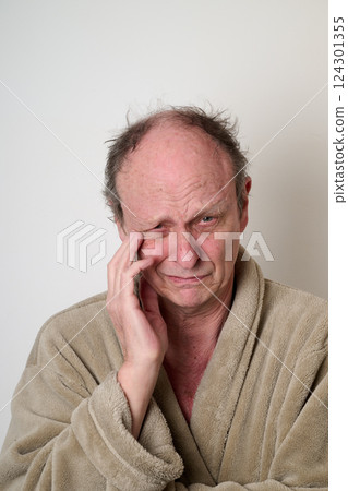 Old man beige bathrobe and tousled hair Old man beige bathrobe and tousled hair 124301355