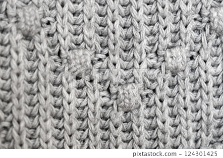 knitted texture, grey sweater or carpet. industrial knitting of clothes made of wool, acrylic or cotton. 124301425