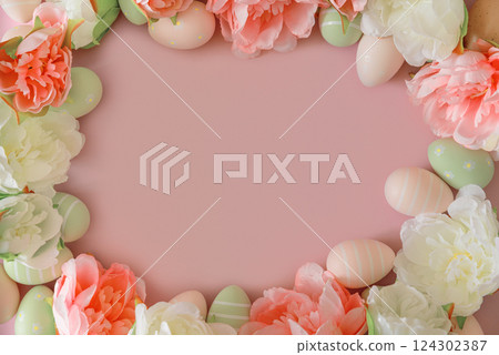 Easter eggs and spring flowers on pastel background. Top view Easter eggs and spring flowers on pastel background. Top view 124302387