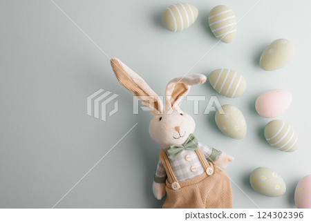 Easter eggs and rabbit toy on pastel background. Top view 124302396