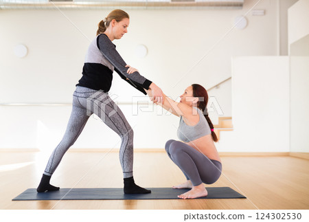 Pregnant woman doing yoga in the gym Pregnant woman doing yoga in the gym 124302530
