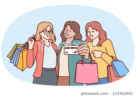 Women show off credit card for shopping and hold packages from boutiques after going to mall 124302693