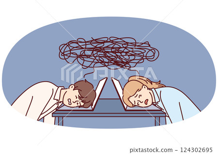 Tired office workers put their heads on table with laptop due to workplace overload 124302695