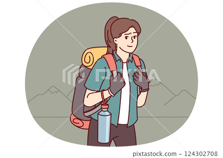 Woman tourist returns from hiking with large backpack on back and bottle water posing near mountains 124302708