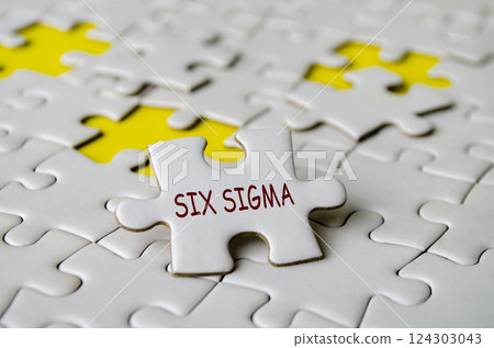 Six Sigma text on jigsaw puzzle. A methodology and set of tools used to improve business processes concept Six Sigma text on jigsaw puzzle. A methodology and set of tools used to improve business processes concept 124303043