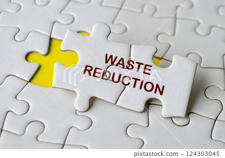 Waste Reduction text on jigsaw puzzle. Process improvement concept Waste Reduction text on jigsaw puzzle. Process improvement concept 124303045