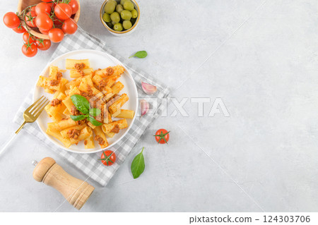 Italian rigatoni pasta with beef Bolognese sauce and basil 124303706