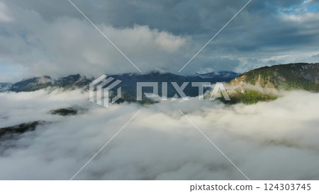 Aerial view of clouds and mountains at sunrise Aerial view of clouds and mountains at sunrise 124303745