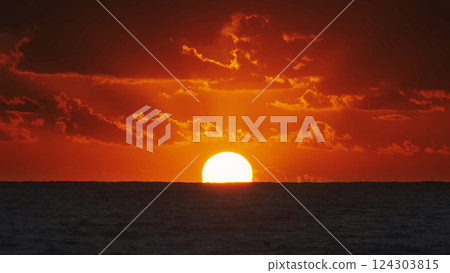 Sunset over ocean with dramatic clouds at dusk 124303815