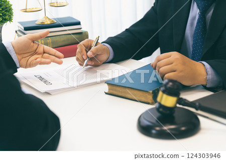 Businessman and lawyer discussing the contract. Sign a contract business. Treaty of the law. Law and Legal services concept. Businessman and lawyer discussing the contract. Sign a contract business. Treaty of the law. Law and Legal services concept. 124303946