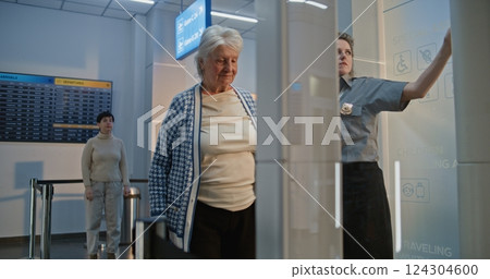 Security Checkpoint: Elderly Woman Getting Up from Wheelchair, Walking Through Metal Detector Scanning Gate 124304600