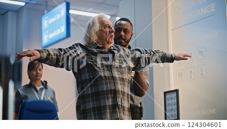 Airport Terminal: Security Officer Inspecting Elderly Man Getting Up from Wheelchair Airport Terminal: Security Officer Inspecting Elderly Man Getting Up from Wheelchair 124304601