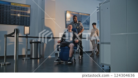 Airport: Man with Prosthetic Leg Getting Up from Wheelchair, Passing X-ray Metal Detector Scanner 124304636