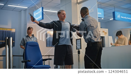 Airport Terminal: Security Officer Inspecting Young Man with Prosthetic Leg in Wheelchair 124304651