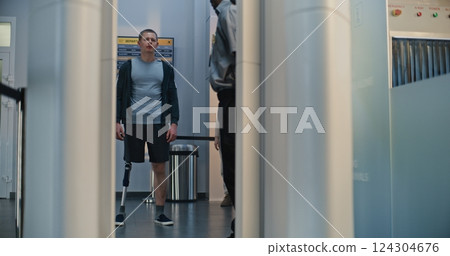 Man with Prosthetic Leg and Adult Woman Walking Through X-ray Metal Detector Scanner Man with Prosthetic Leg and Adult Woman Walking Through X-ray Metal Detector Scanner 124304676
