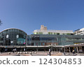 A lively morning in front of JR Takamatsu Station - the station square with a clear blue sky and people coming and going 124304853