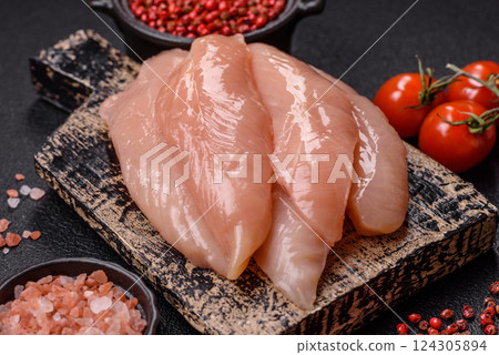 Raw chicken fillet cut into strips with spices and herbs Raw chicken fillet cut into strips with spices and herbs 124305894