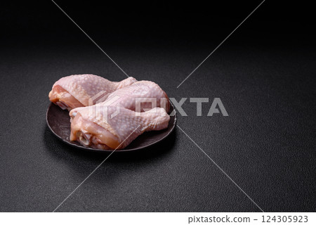 Raw chicken legs with salt, spices and herbs Raw chicken legs with salt, spices and herbs 124305923