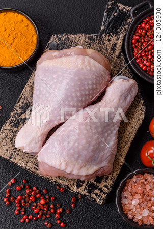 Raw chicken legs with salt, spices and herbs 124305930