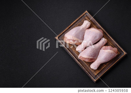 Raw chicken legs with salt, spices and herbs Raw chicken legs with salt, spices and herbs 124305938