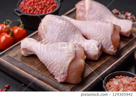Raw chicken legs with salt, spices and herbs Raw chicken legs with salt, spices and herbs 124305942