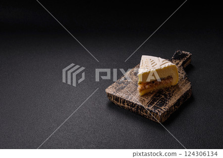Piece of cheesecake with nuts and berries with winter pattern Piece of cheesecake with nuts and berries with winter pattern 124306134