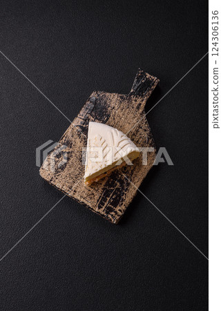 Piece of cheesecake with nuts and berries with winter pattern Piece of cheesecake with nuts and berries with winter pattern 124306136