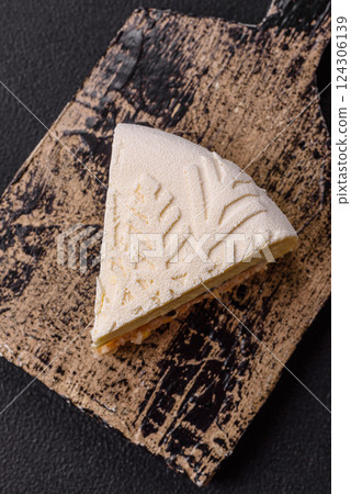 Piece of cheesecake with nuts and berries with winter pattern 124306139