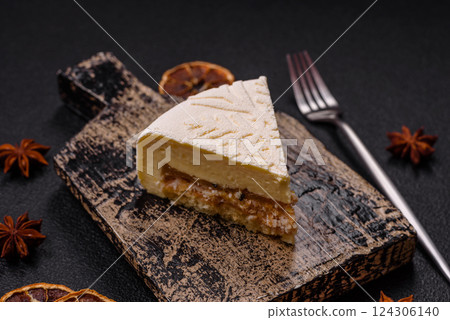 Piece of cheesecake with nuts and berries with winter pattern 124306140