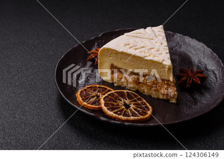 Piece of cheesecake with nuts and berries with winter pattern 124306149