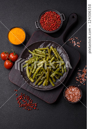 Steamed green beans on a plate with olive oil, sesame seeds 124306358