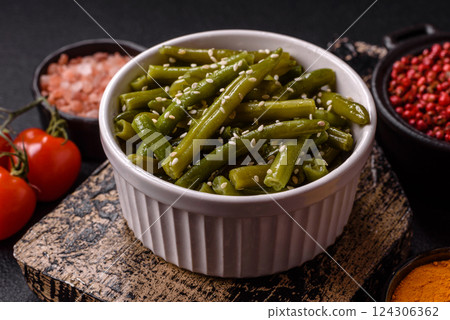 Steamed green beans on a plate with olive oil, sesame seeds 124306362