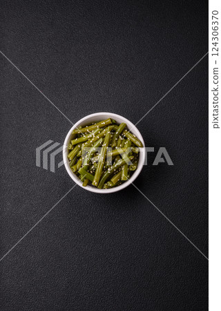 Steamed green beans on a plate with olive oil, sesame seeds 124306370