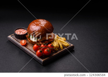 Delicious burger with beef patty, fried egg, bacon, herbs, sauce, salt and spices 124306584