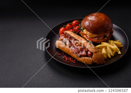 Delicious juicy hot dog with sausage, bacon, sauce, salt and spices 124306587