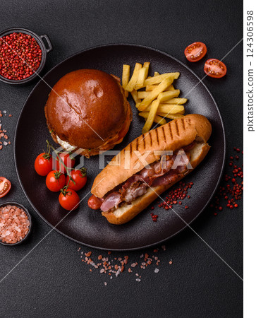 Delicious juicy hot dog with sausage, bacon, sauce, salt and spices Delicious juicy hot dog with sausage, bacon, sauce, salt and spices 124306598
