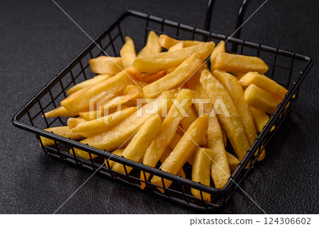 Delicious crispy French fries with salt and spices 124306602