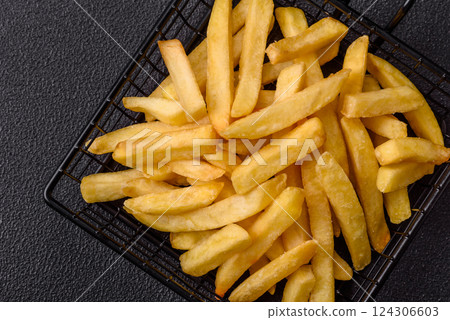 Delicious crispy French fries with salt and spices 124306603