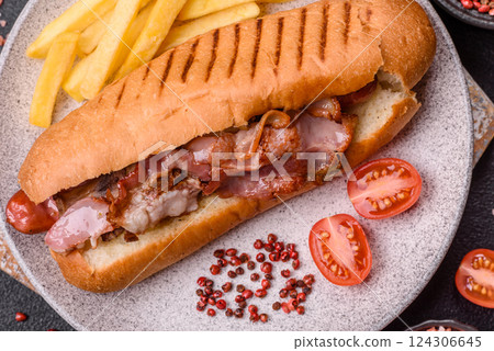 Delicious juicy hot dog with sausage, bacon, sauce, salt and spices Delicious juicy hot dog with sausage, bacon, sauce, salt and spices 124306645