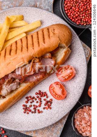 Delicious juicy hot dog with sausage, bacon, sauce, salt and spices 124306646
